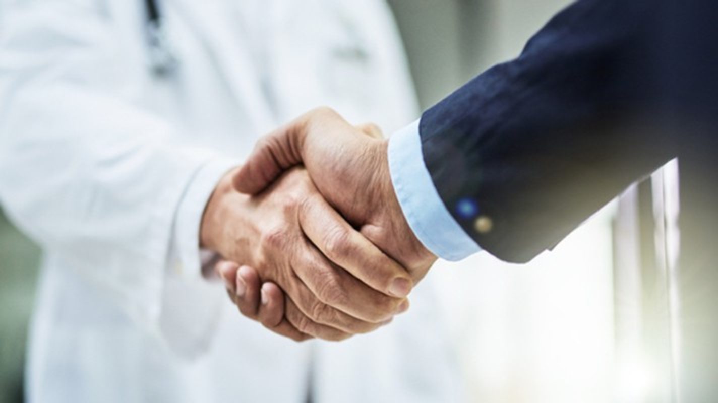 A partnership handshake in a care setting